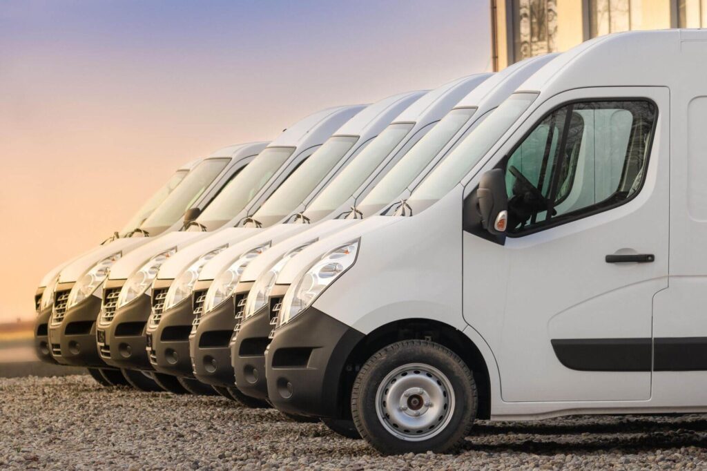 vans parked together to deliver goods, amazon or hermes