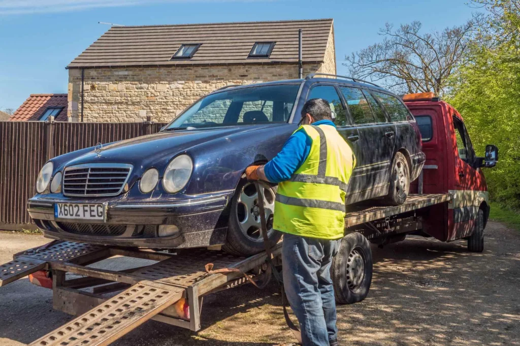 Impounded vehicle being taken away on the back of a truck