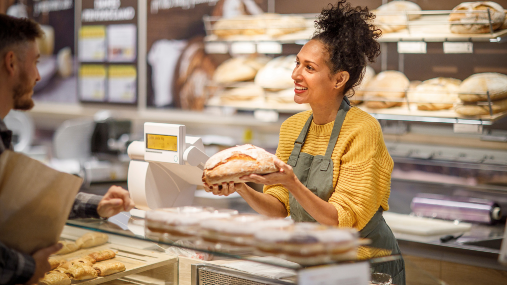 woman behind counter at a bakery